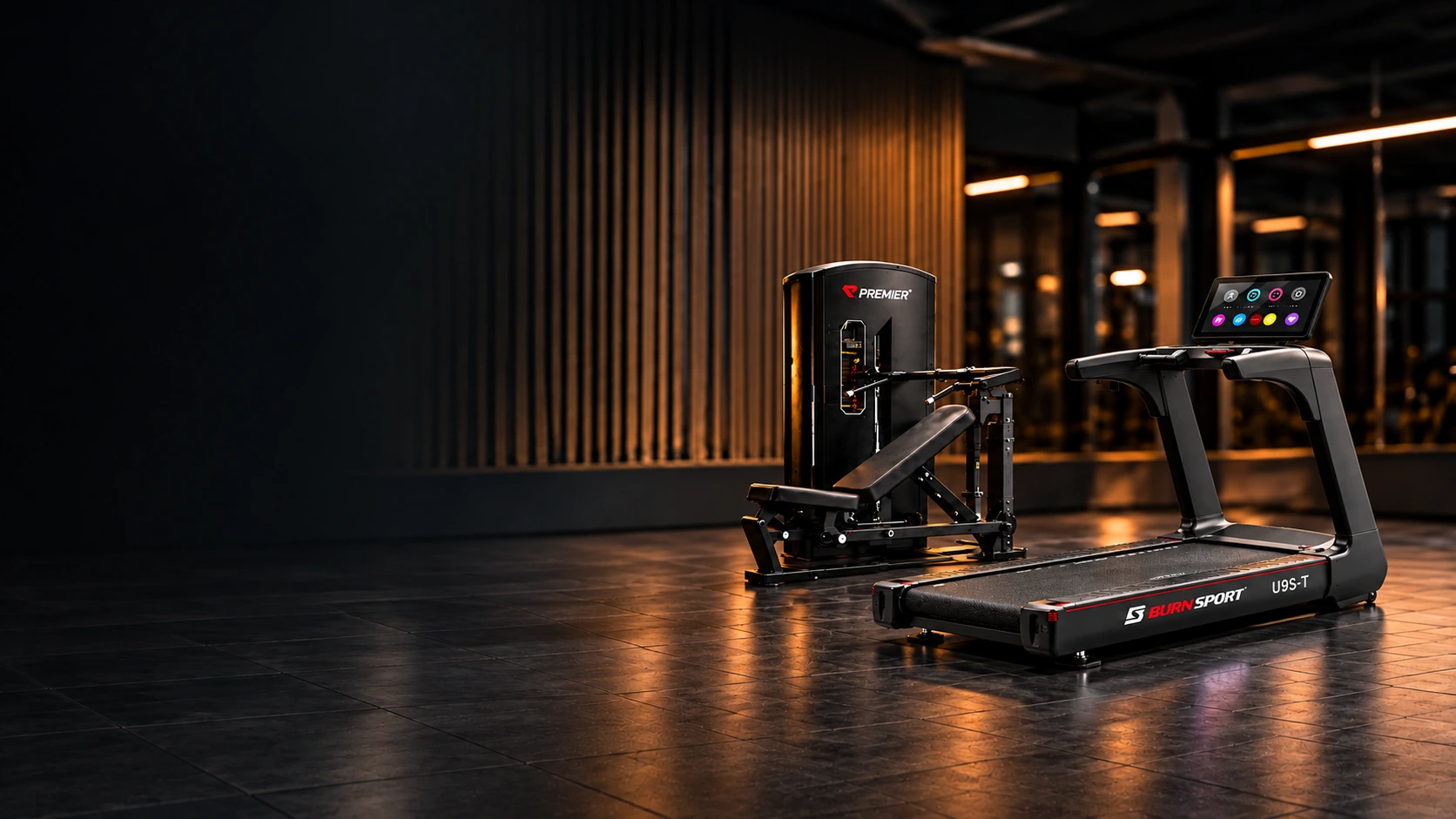 Premier strength equipment and a clearly visible Burnsport treadmill in a dark gym with warm amber lighting.